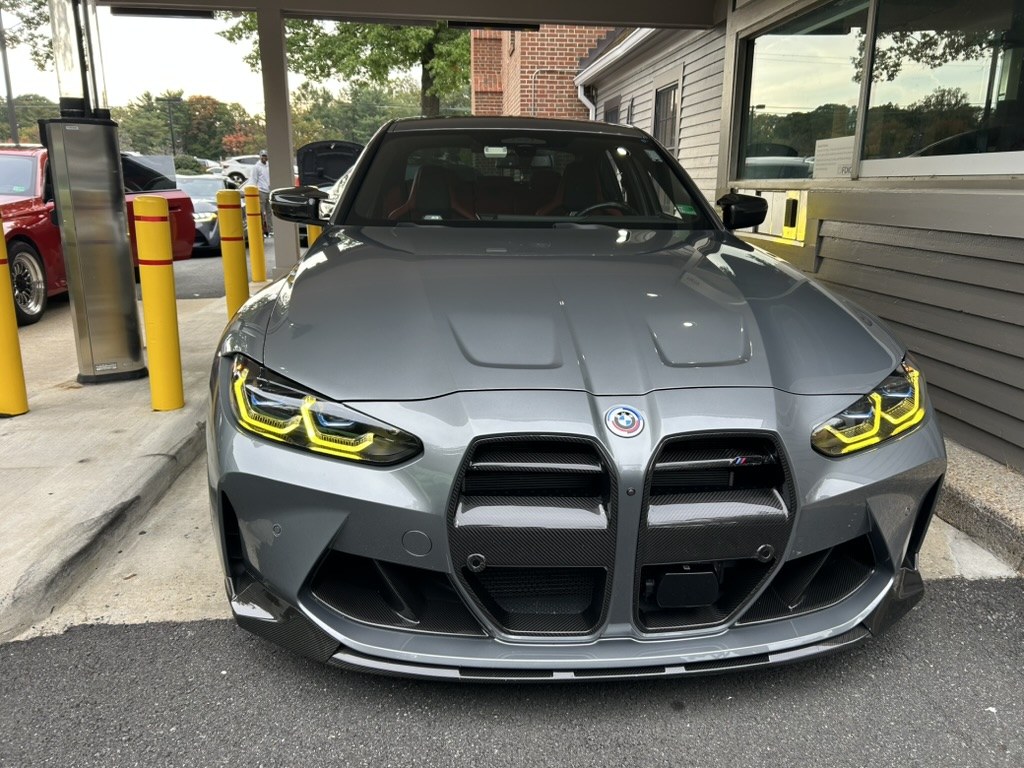 Carbon fibre splitter, canards and grille surround, with the yellow daytime running light signature.