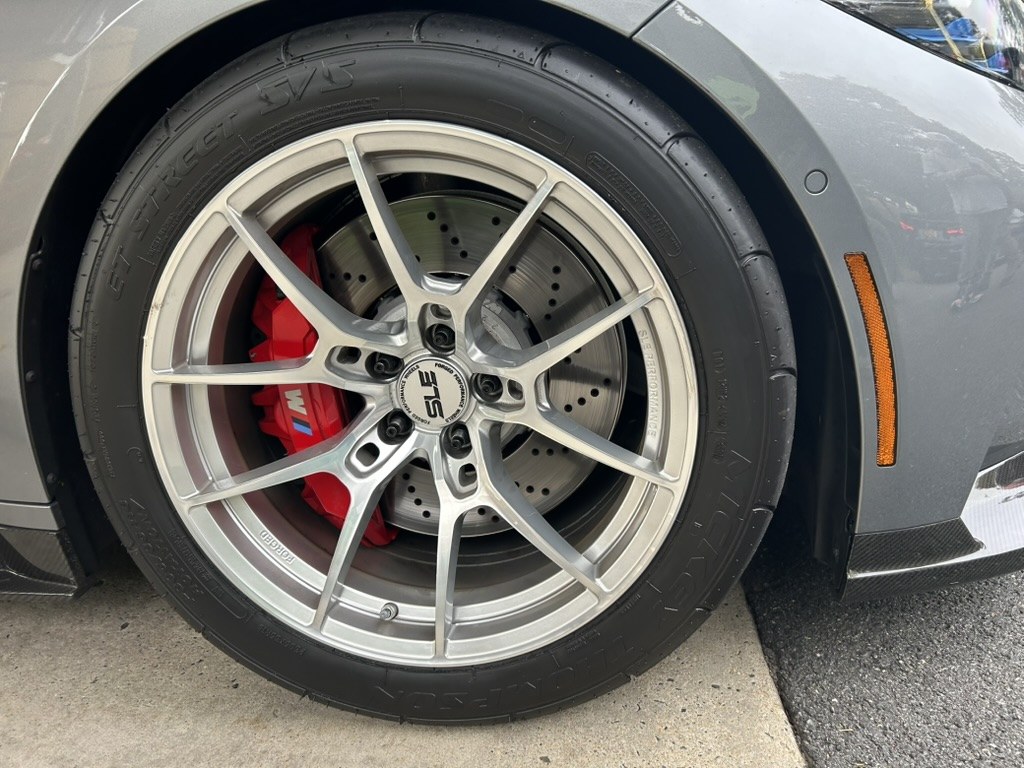 SLE forged wheel, silver machined, on a Mickey Thompson ET Street S/S. Red M calipers over drilled rotors. Size and offset not identified.